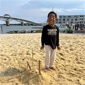 Boy playing in the sand at Yorktown Beach