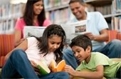 Family reading books at a library